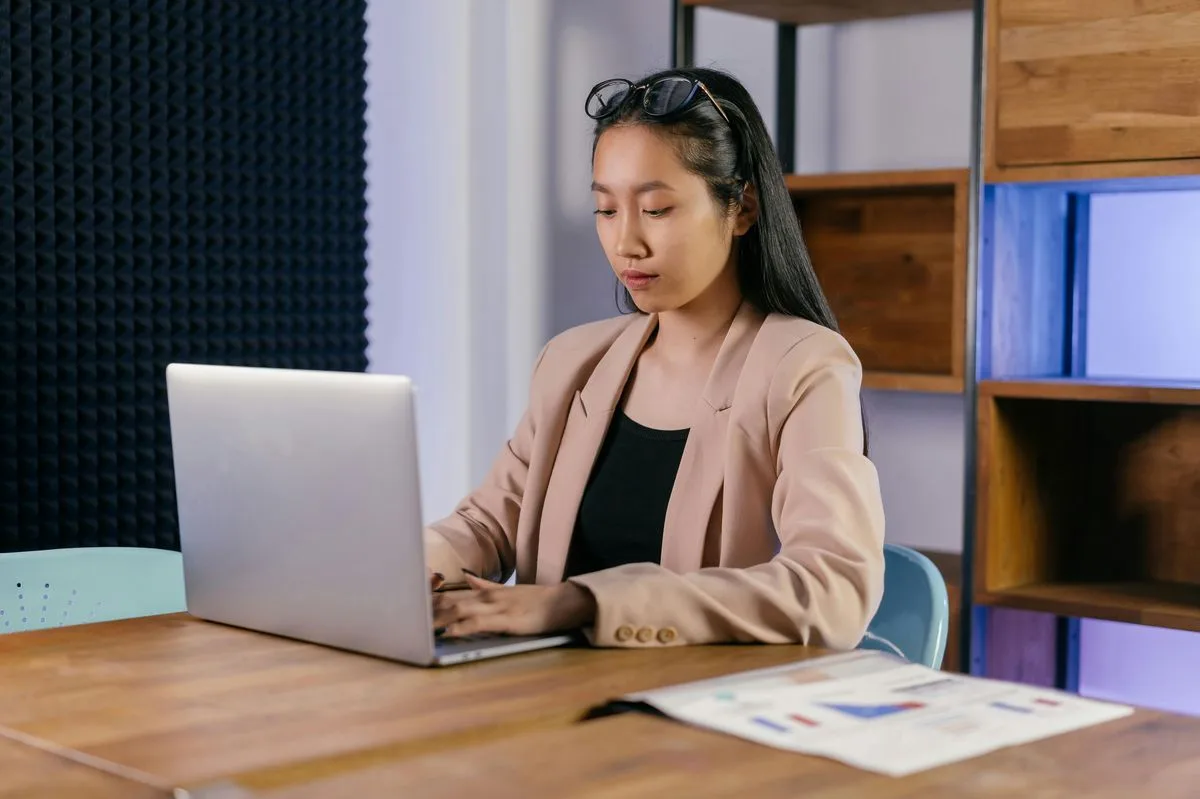 Woman working on her laptop doing cold emails during optimal days