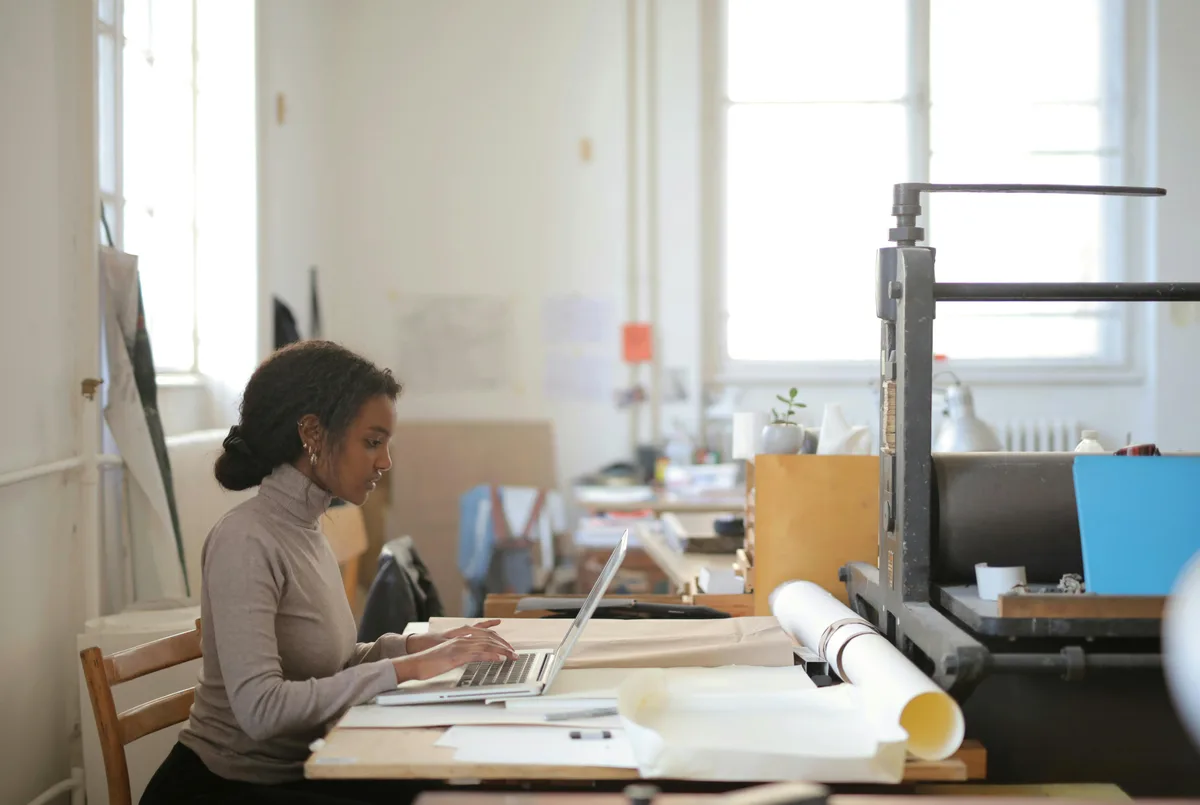 Woman using laptop doing cold emails
