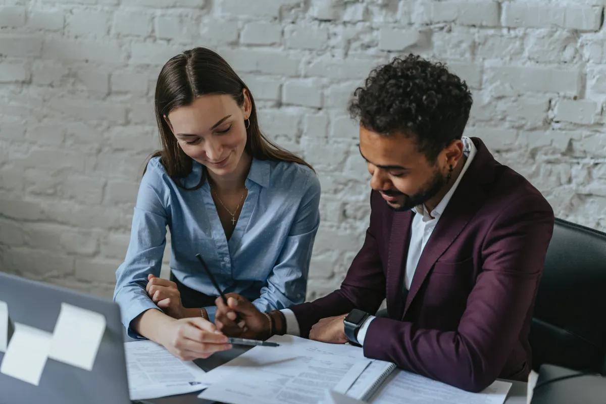 Mortgage broker with a man signing a contract