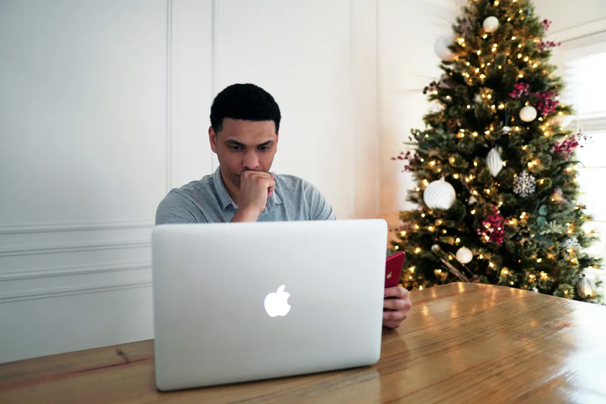 Homebuyer sitting in front of a silver macbook