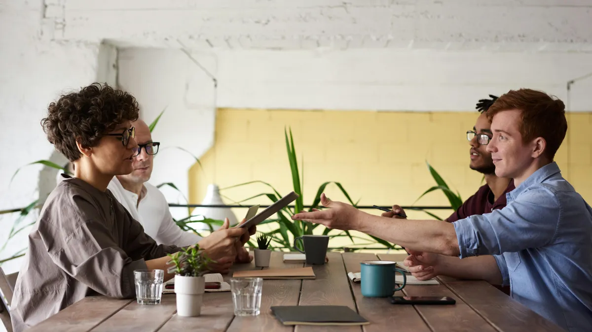 Broker discussing mortgage fee to clients