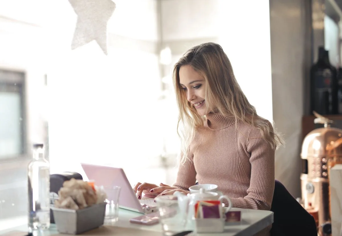 Woman using a laptop sending bulk cold emails